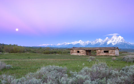 The old Cunningham Cabin at sunrise with a moonset in Grand Teton National Park